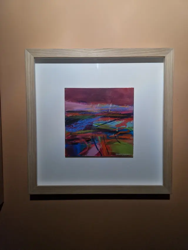 A small abstract landscape painting deep-mounted in a pale limed wood frame